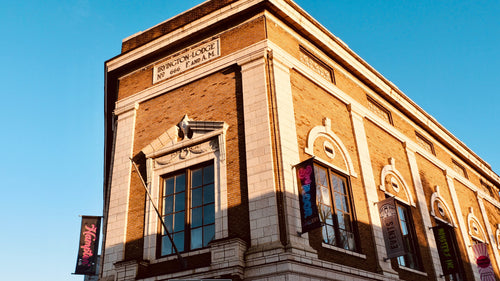 Building exterior with architectural details against a clear blue sky