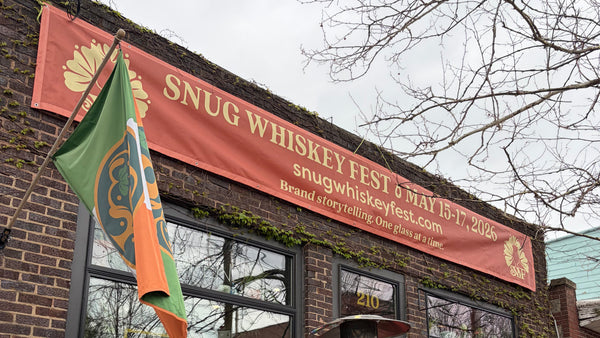 Brick building with a red sign and outdoor seating area