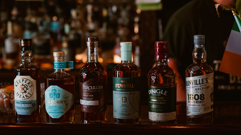 Row of whiskey bottles on a bar with blurred background